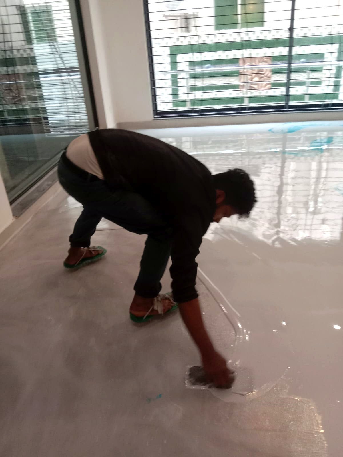 Epoxy flooring services: epoxy being rolled out