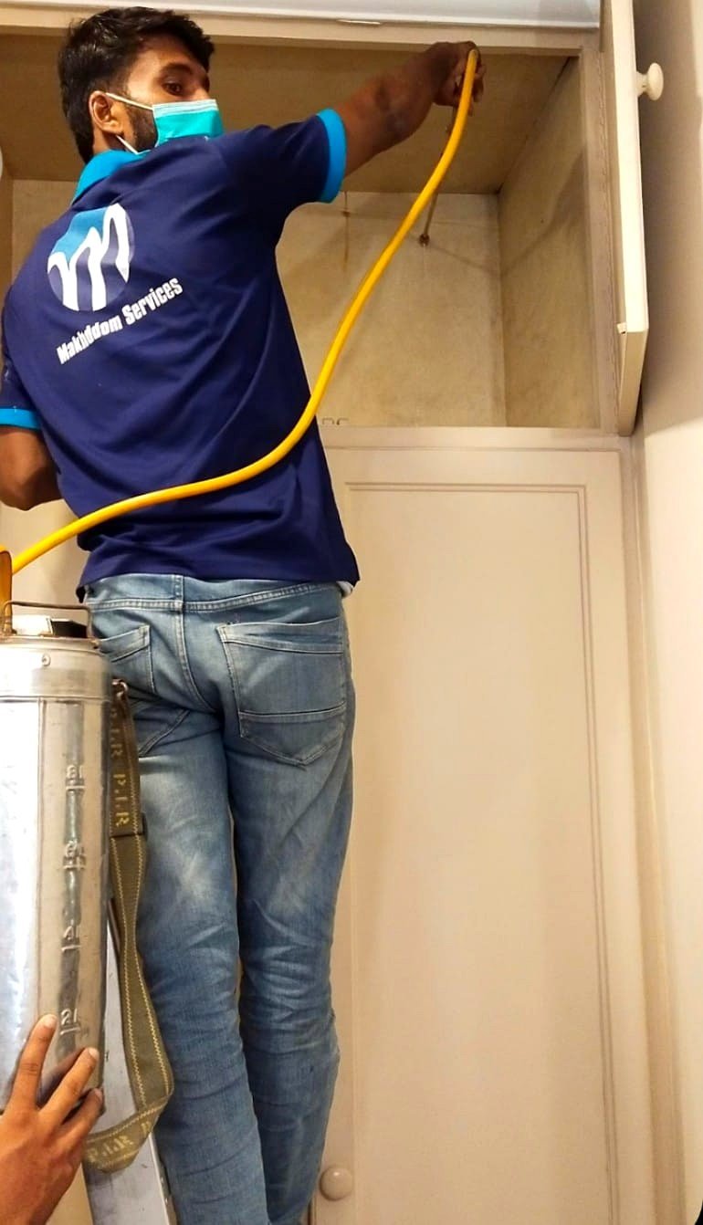 Makhdoom Services technician treating a wardrobe for termites